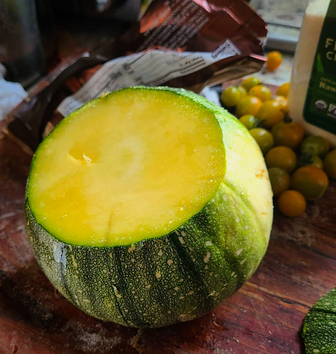 The same fruit, sliced in half to show creamy yellow flesh.