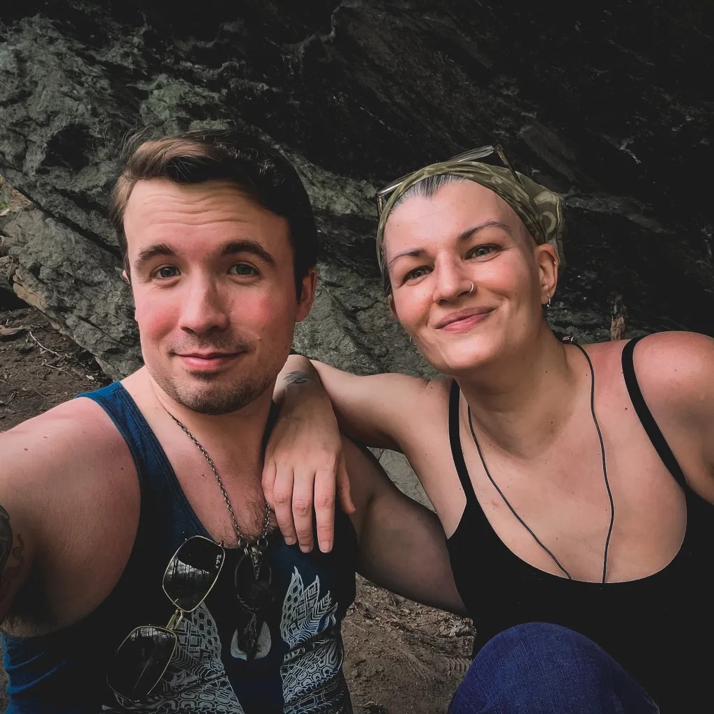 The author and their Handsome Assistant sitting together under the rock shelter.