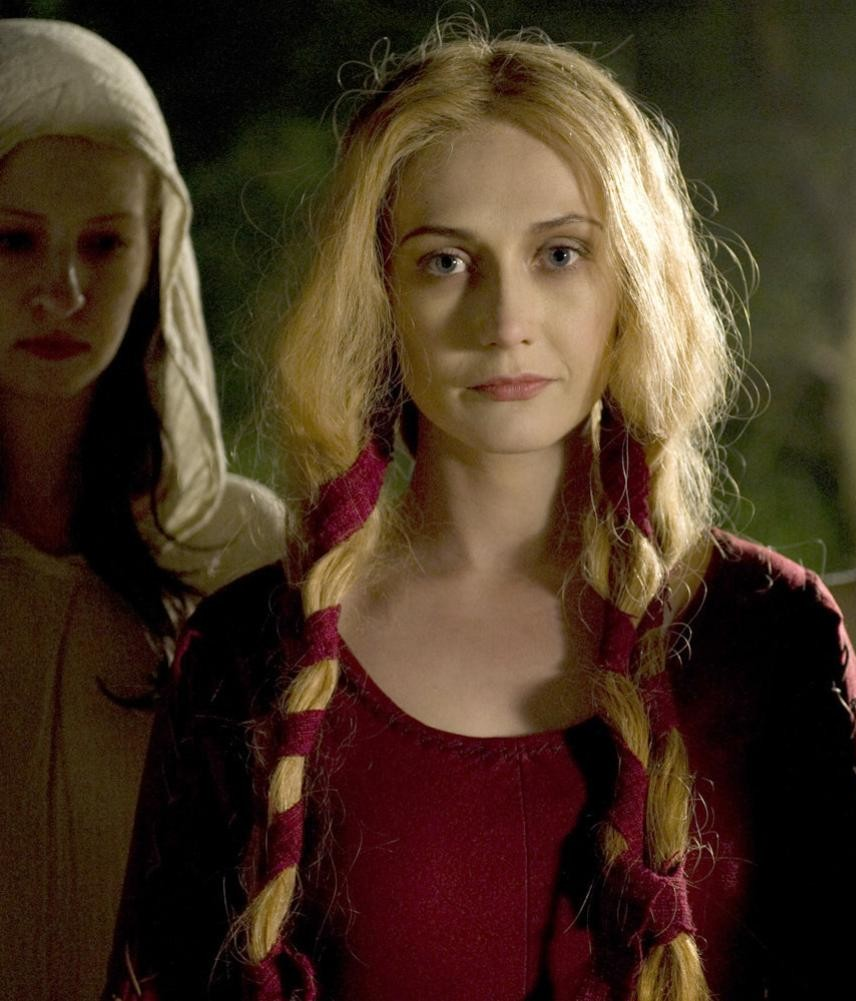 Carice Van Houten as Langiva. A pale woman with long blonde hair, in a dark red dress. 